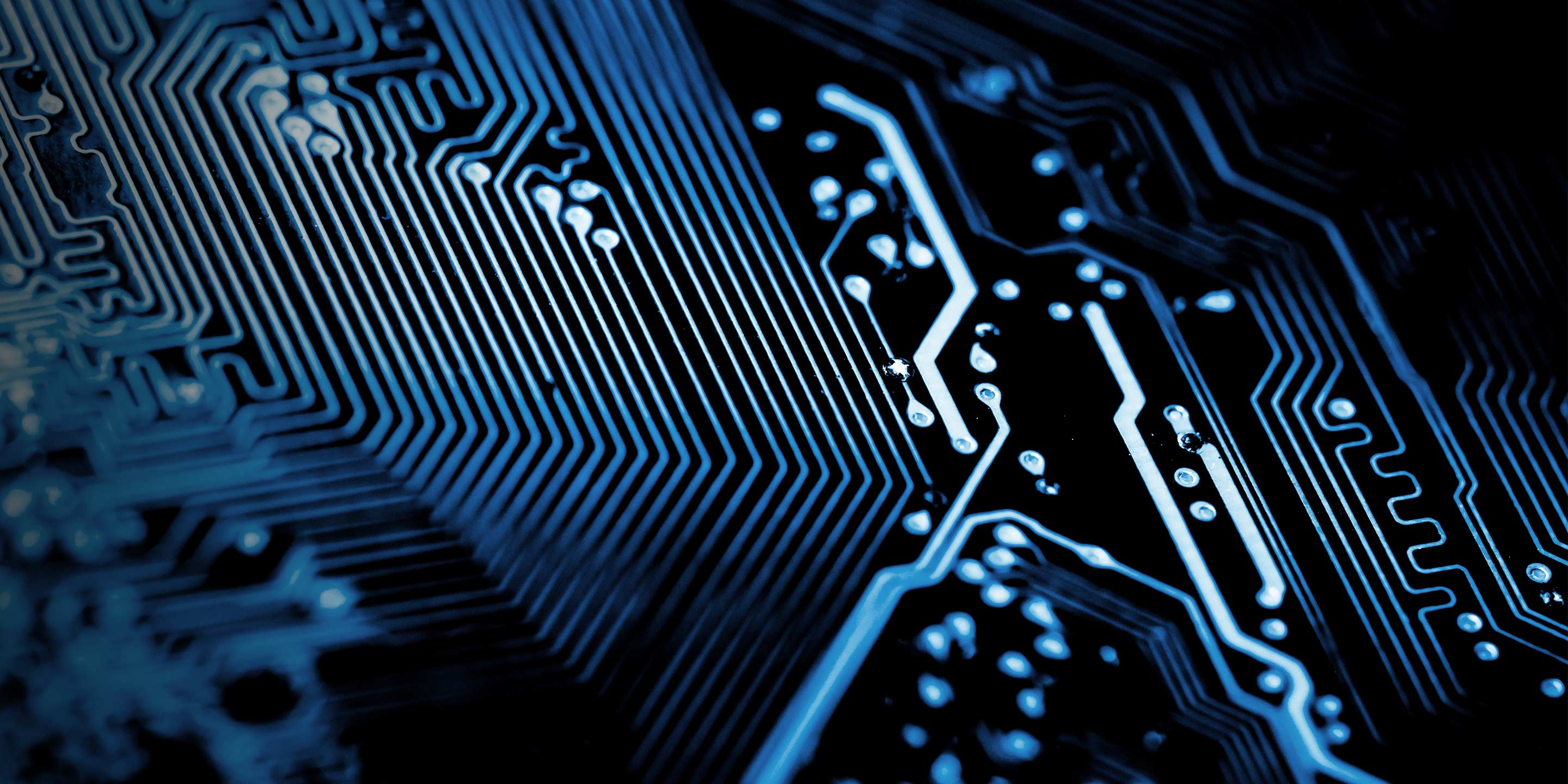 Close-up of blue electronic chip with glowing circuitry