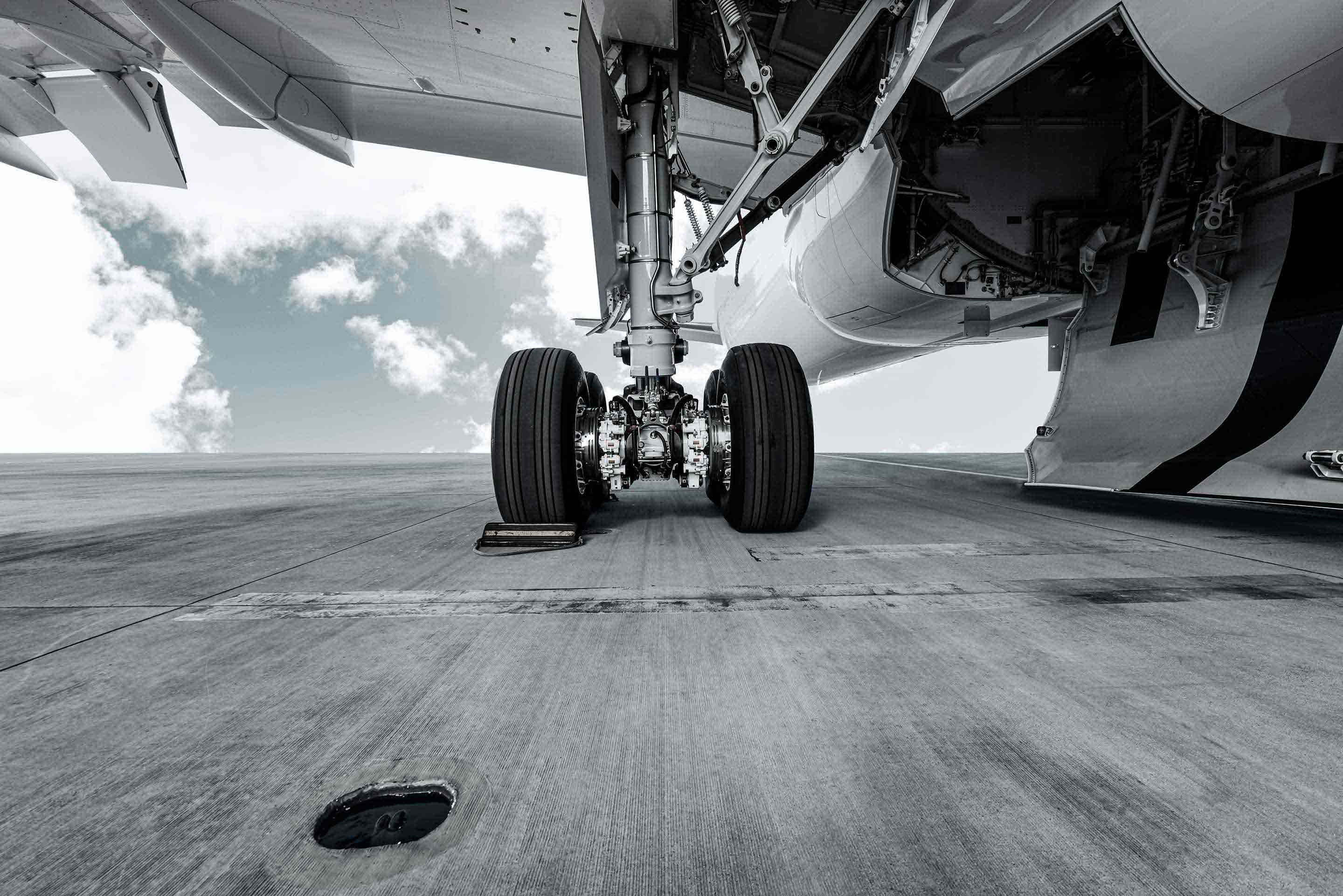 Low-angle perspective of aircraft landing gear on tarmac